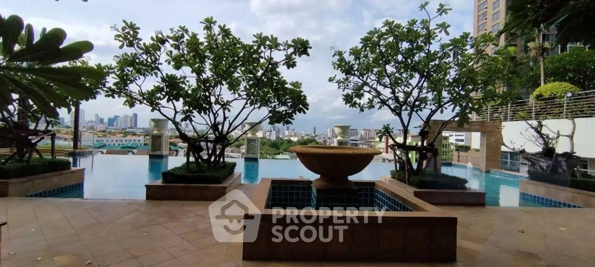 Luxurious rooftop pool with stunning city view and lush greenery