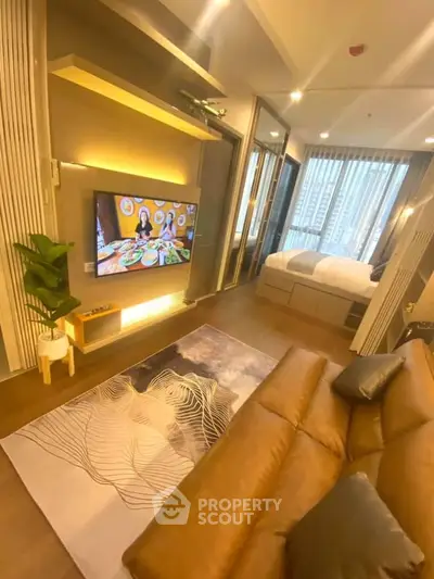 Modern living room with stylish decor and cozy bedroom view in luxury apartment.