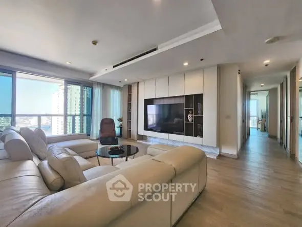 Spacious modern living room with large windows and sleek furniture