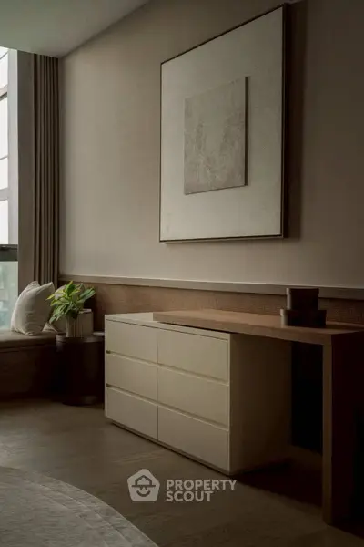 Elegant modern interior with stylish furniture and large window, perfect for a cozy living space.
