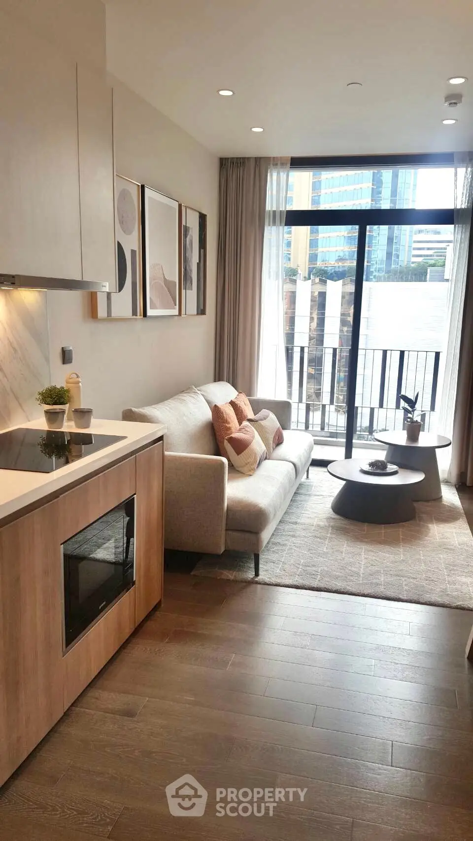 Modern living room with cozy sofa, stylish decor, and balcony view in urban apartment.