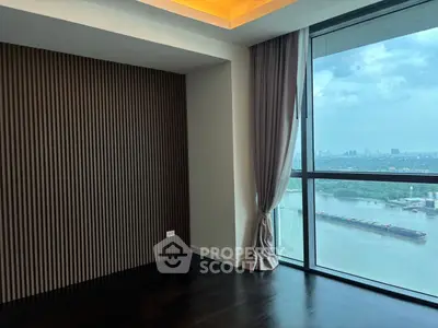Luxurious corner unit with stunning river view and floor-to-ceiling windows.