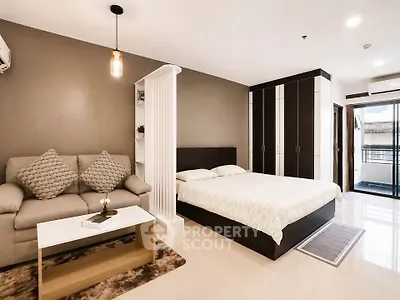 Modern studio apartment with cozy living area and stylish bedroom