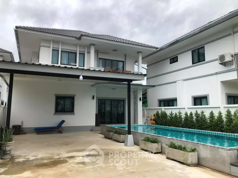 Modern two-story house with private pool and spacious patio area.