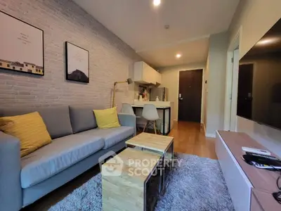 Modern living room with cozy sofa, stylish decor, and open kitchen layout in a contemporary apartment.