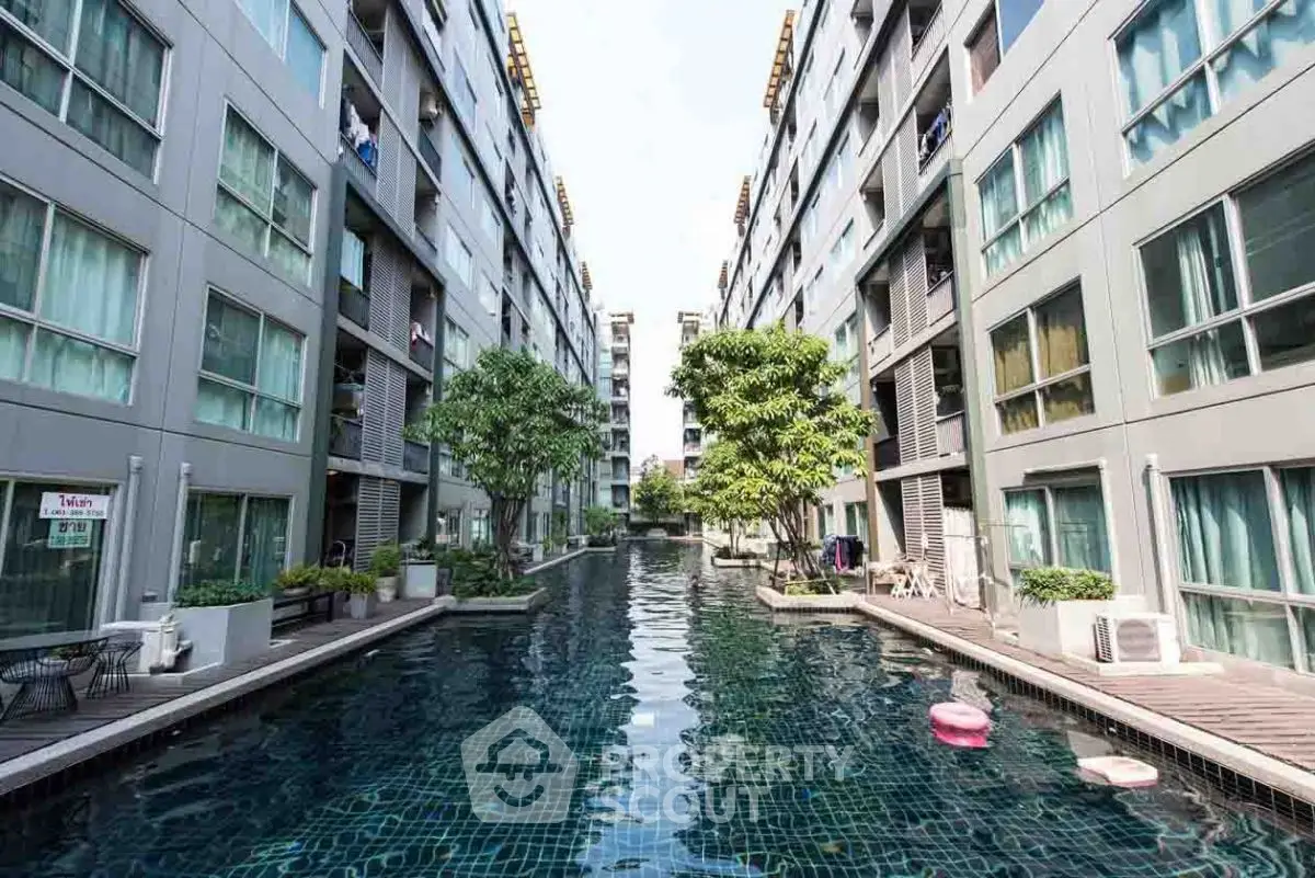 Luxurious apartment complex with stunning pool view and modern architecture.