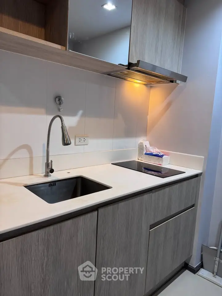 Modern kitchen with sleek cabinetry and built-in stovetop, ideal for contemporary living.