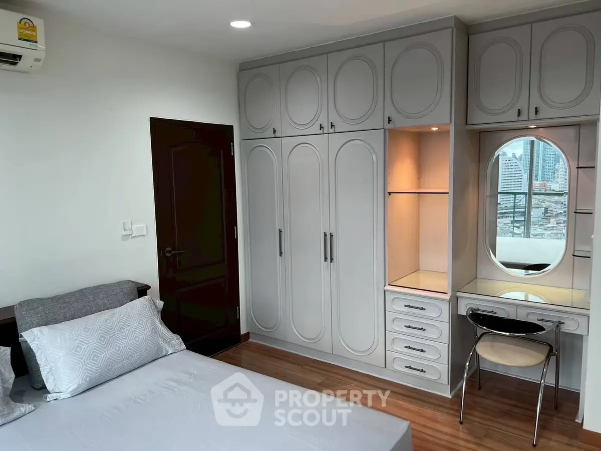 Modern bedroom with built-in wardrobe and city view