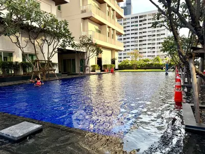 Luxurious residential building with stunning pool and lush greenery