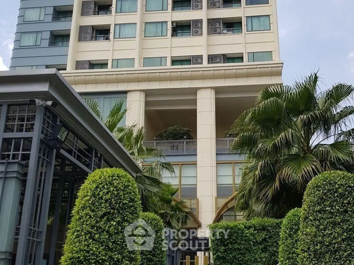 Luxurious high-rise building with lush greenery and modern architecture.