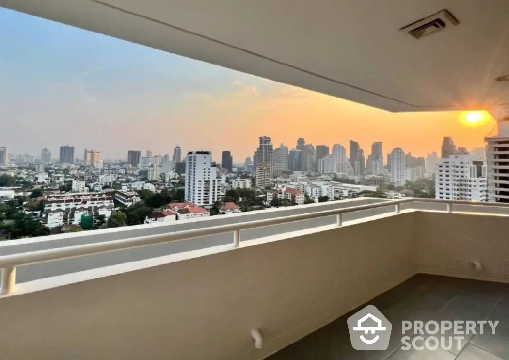 Stunning cityscape view from spacious balcony at sunset