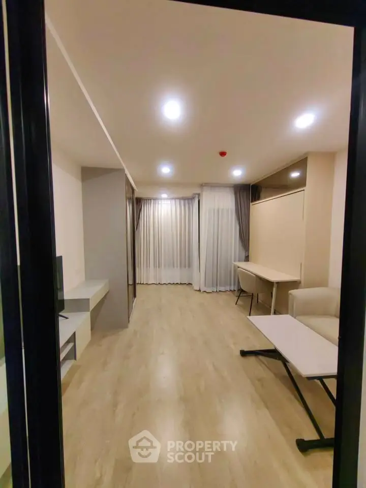 Spacious modern living room with elegant lighting and stylish furniture, perfect for relaxation and entertainment.