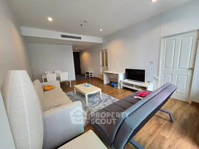 Spacious modern living room with stylish furniture and wooden flooring in a contemporary apartment.