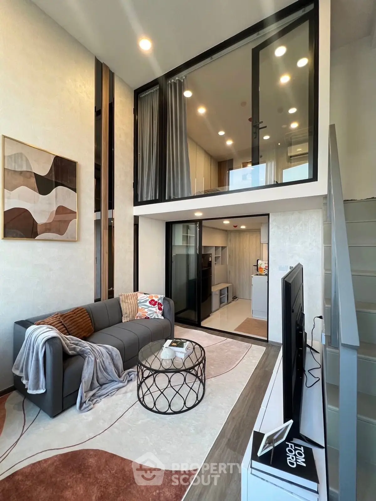 Modern loft-style living room with high ceiling and stylish decor