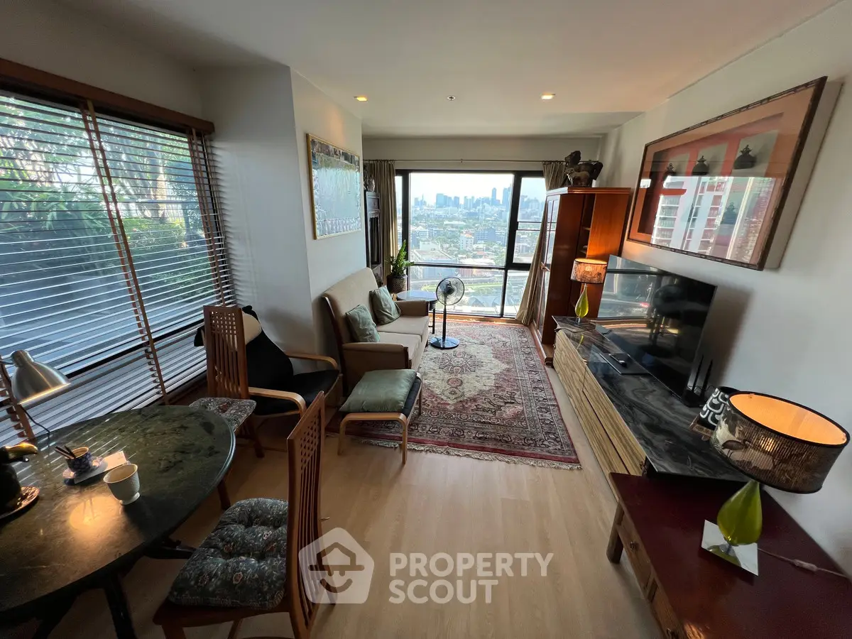 Spacious living room with city view, elegant decor, and natural light