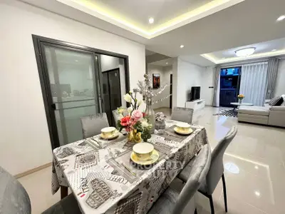 Elegant dining area with modern decor and open living room in a stylish apartment.