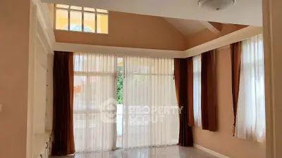 Spacious living room with high ceilings and large windows for natural light