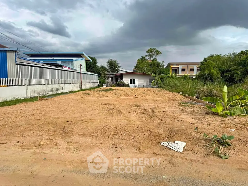 Vacant land plot with potential for development under cloudy skies