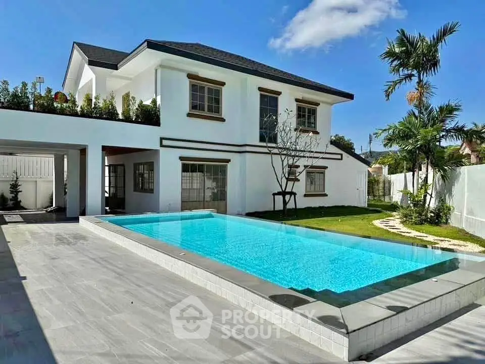 Luxurious modern house with stunning pool and lush garden, perfect for relaxation and entertainment.