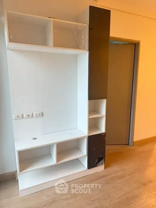 Modern interior with built-in shelving unit and wooden flooring