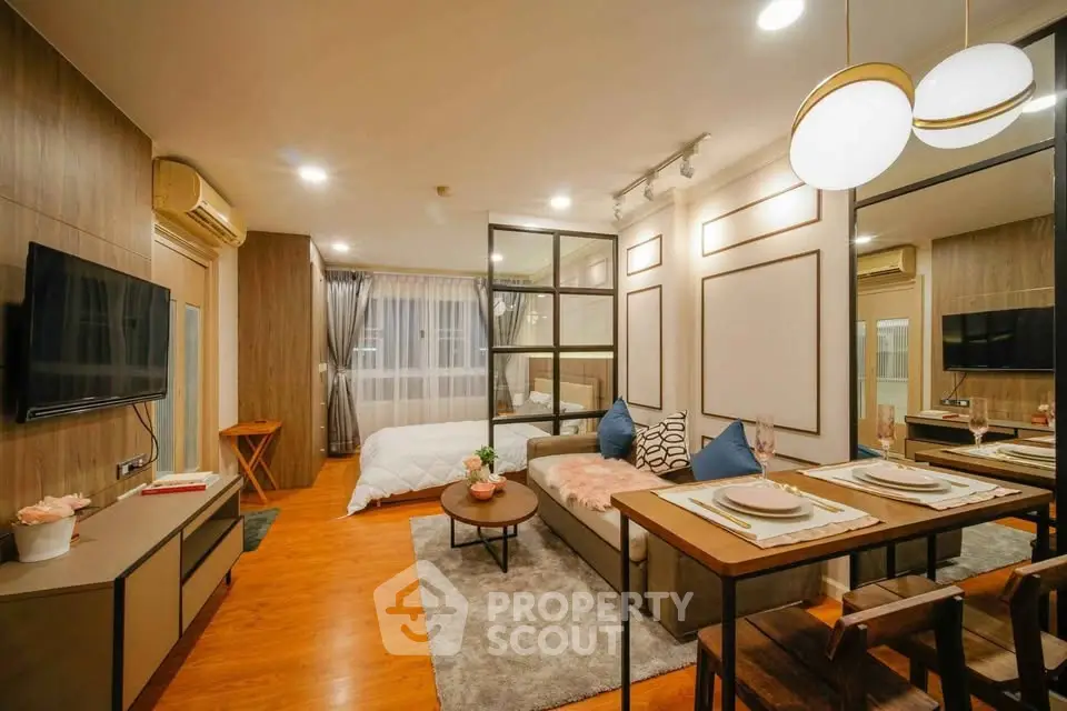 Stylish open-plan living room with modern decor and cozy bedroom area