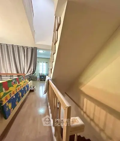 Charming interior with wooden staircase and cozy living area, perfect for family gatherings.