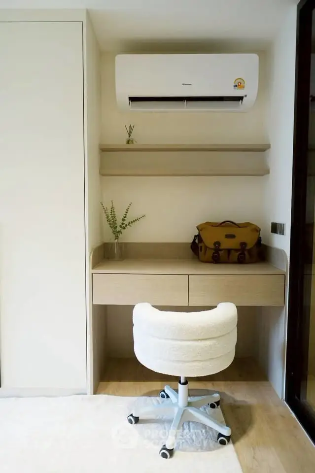 Modern study nook with built-in desk, cozy chair, and air conditioning unit, perfect for productivity.