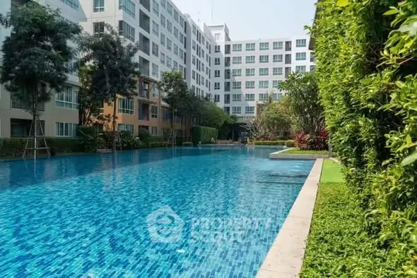 Luxurious apartment complex with a stunning outdoor pool and lush greenery, perfect for relaxation and leisure.