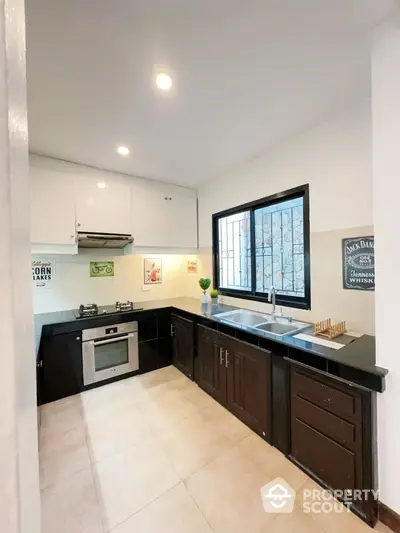 Modern kitchen with sleek black countertops and built-in oven