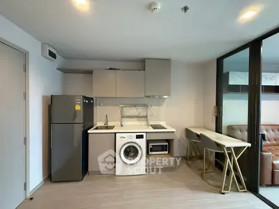 Modern kitchen with integrated appliances and stylish seating area