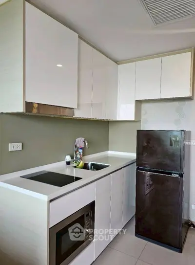 Modern kitchen with sleek cabinets and appliances in a stylish apartment