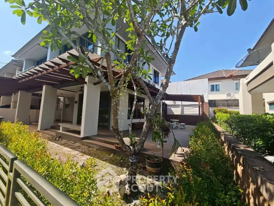 Charming two-story house with lush garden and spacious patio in a serene neighborhood.