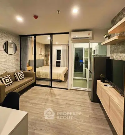 Modern open-plan living room with glass partition to bedroom, featuring sleek furniture and stylish decor.