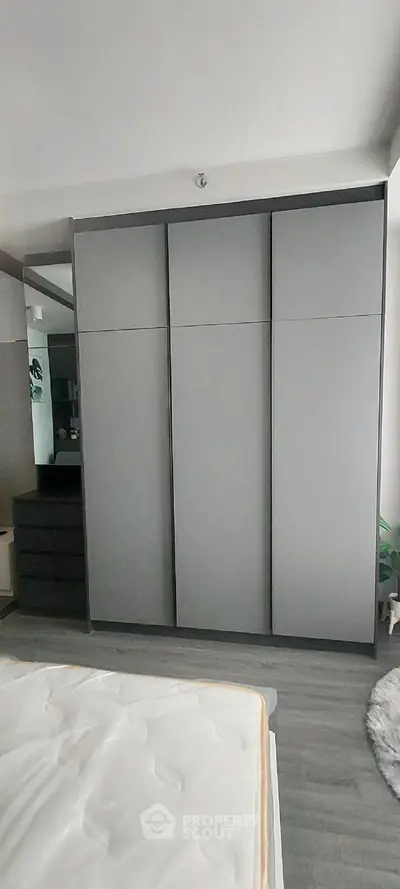 Modern bedroom with sleek wardrobe and minimalist decor