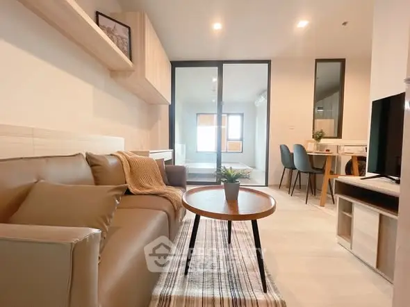 Modern living room with cozy sofa and stylish decor in open layout apartment.