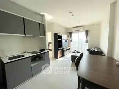 Modern open-plan living room with kitchen, dining area, and city view.