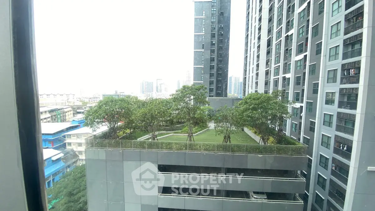 Modern urban building with rooftop garden offering a serene green space amidst cityscape.