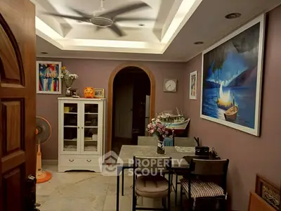 Charming dining area with modern decor and artistic wall paintings.
