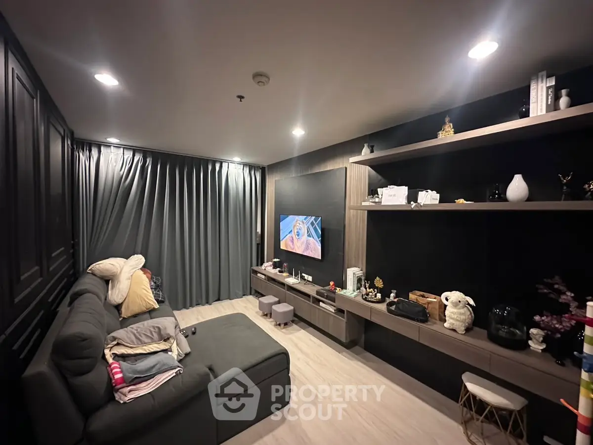 Modern living room with cozy sectional sofa and built-in entertainment center, perfect for relaxation and entertainment.