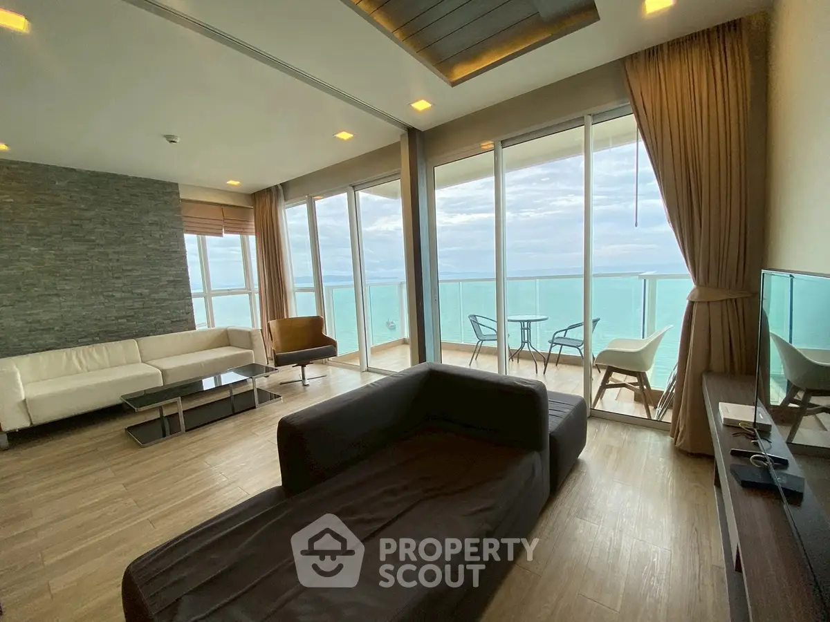 Luxurious living room with stunning ocean view and modern furnishings.