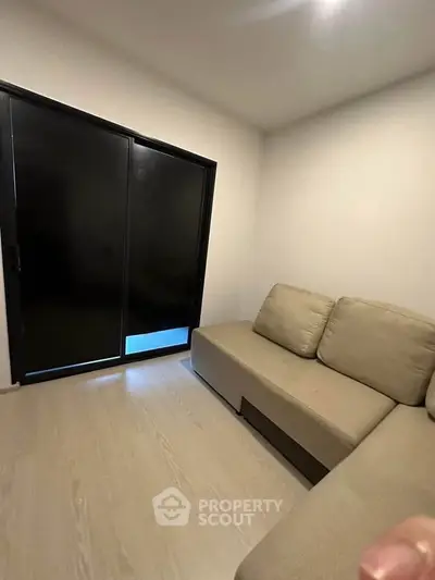 Cozy minimalist living room with modern sofa and sliding glass door