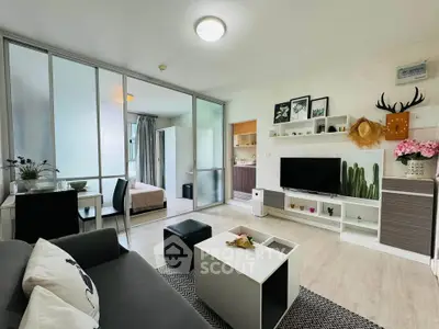 Modern living room with stylish decor and open layout leading to bedroom