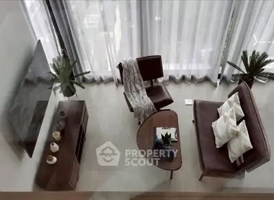 Stylish modern living room with elegant furniture and large windows