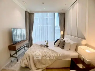 Luxurious bedroom with modern decor and large window offering city views