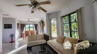 Spacious living room with natural light and modern dining area