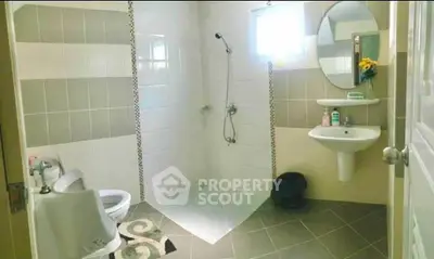 Spacious modern bathroom with sleek tiles and elegant fixtures.