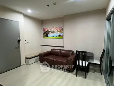 Modern living room with brown leather sofa and dining area in stylish apartment.