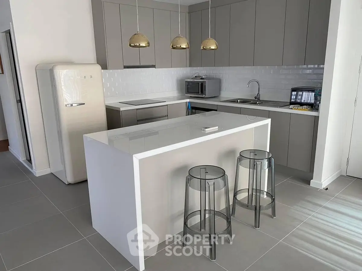 Modern kitchen with sleek cabinetry and breakfast bar in stylish apartment