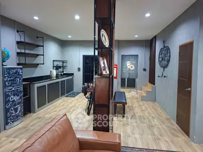 Modern open-layout living room with stylish kitchen and cozy seating area