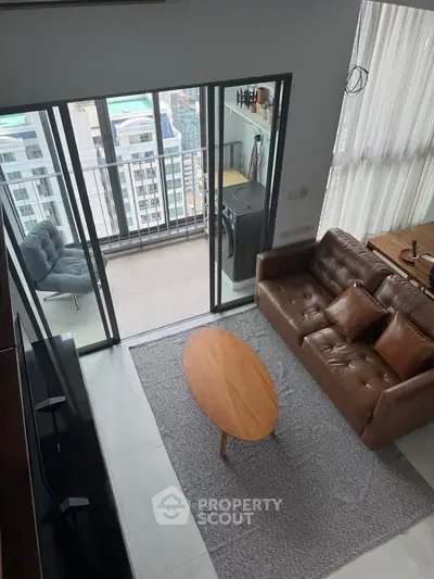Modern living room with balcony view in high-rise apartment